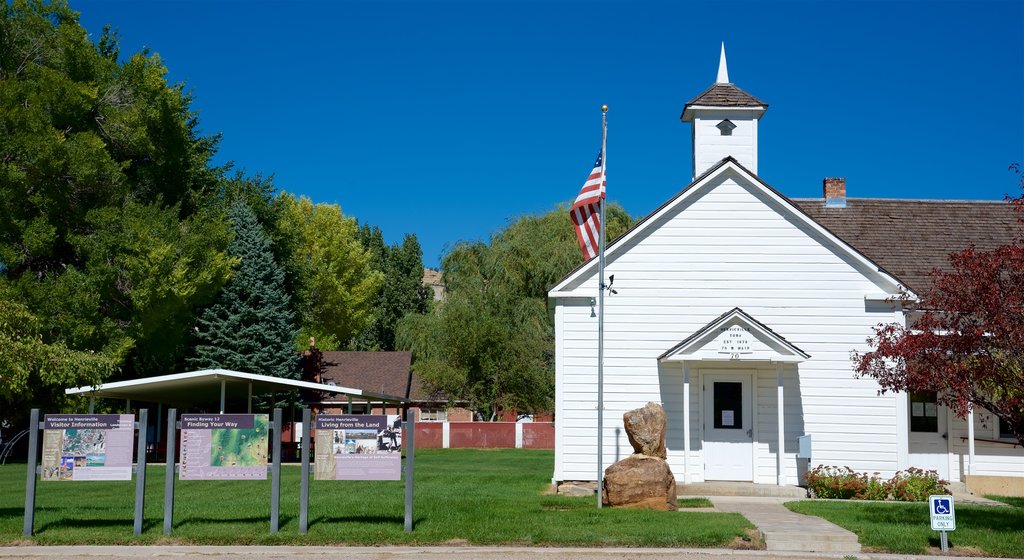 Bryce Canyon National Park featuring a church or cathedral, signage and a garden