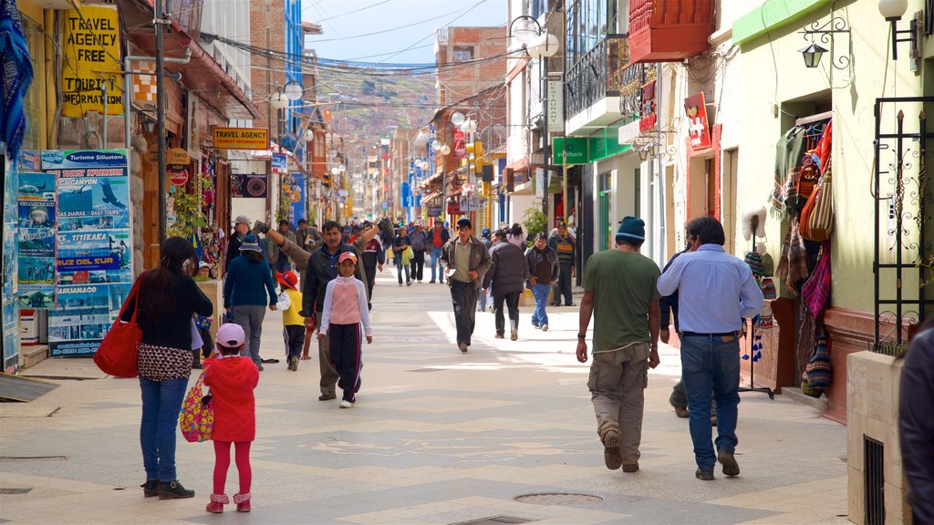 Lake Titicaca showing a city as well as a small group of people