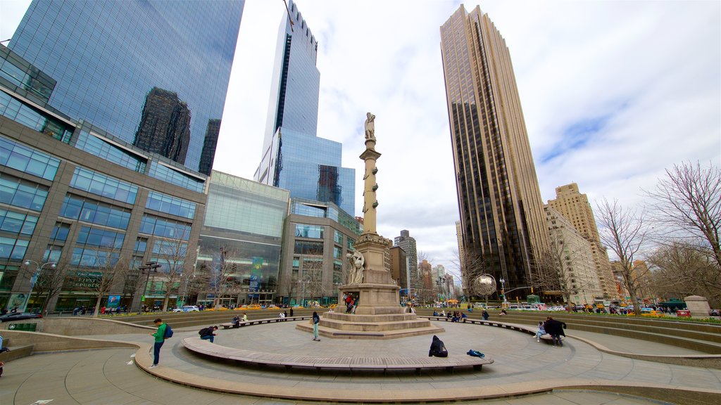 Columbus Circle which includes a high-rise building, a statue or sculpture and a square or plaza