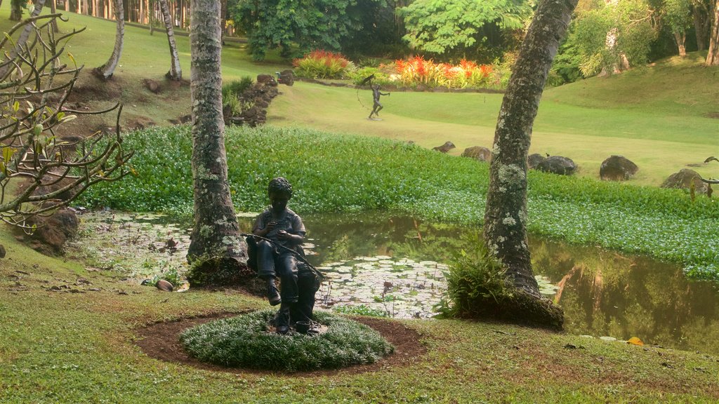 Na Aina Kai Botanical Gardens featuring outdoor art, a pond and a garden