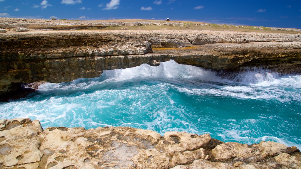 Devil\'s Bridge featuring surf, rugged coastline and general coastal views