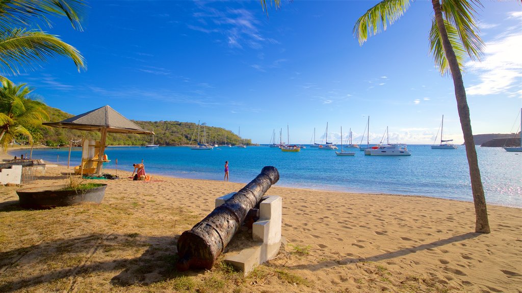 Galleon Beach mostrando una playa de arena, una bahía o un puerto y elementos patrimoniales