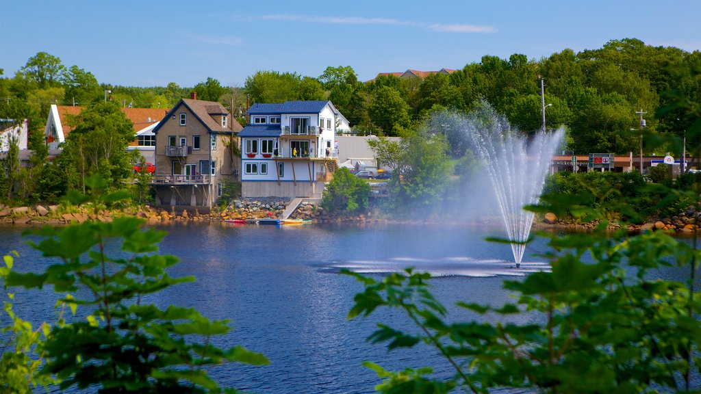 Canada showing a small town or village, a fountain and a lake or waterhole