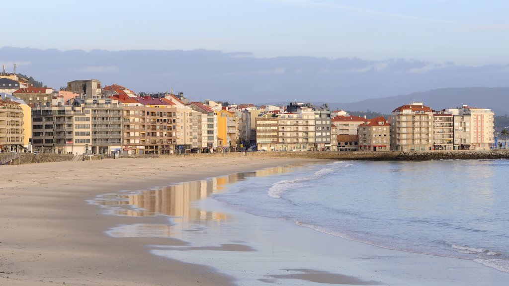 Sanxenxo showing general coastal views, a sandy beach and a coastal town