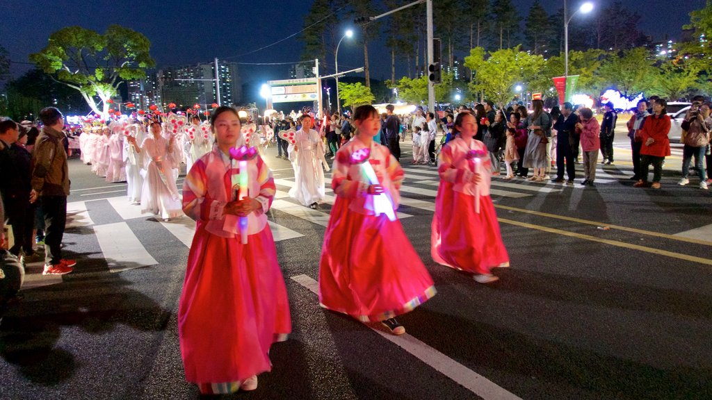 Busan City Centre featuring street performance and night scenes as well as a small group of people