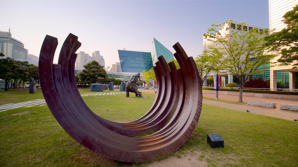 Busan Museum of Art featuring a garden, outdoor art and a sunset