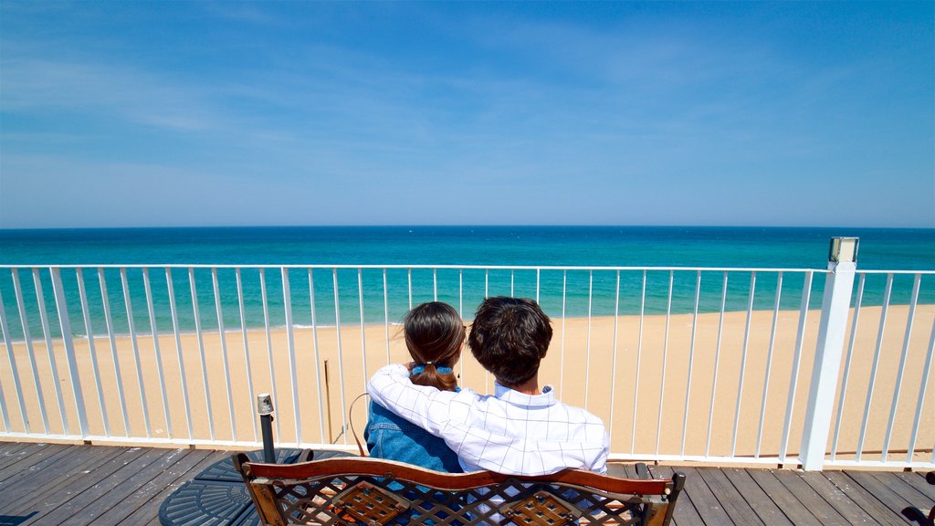 Jeongdongjin Beach featuring a sandy beach and general coastal views as well as a couple