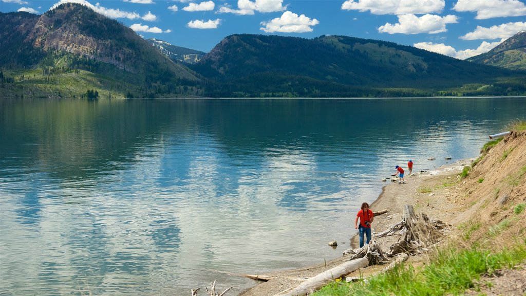 Jackson Lake showing a lake or waterhole as well as a small group of people