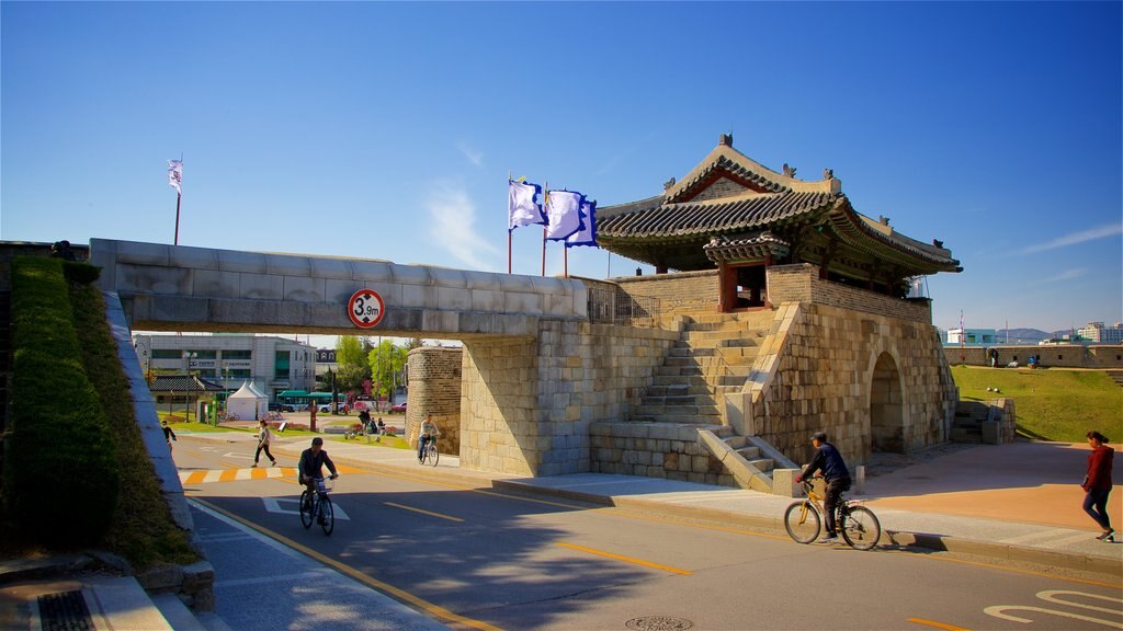 Hwaseomun Gate showing heritage elements, road cycling and a bridge