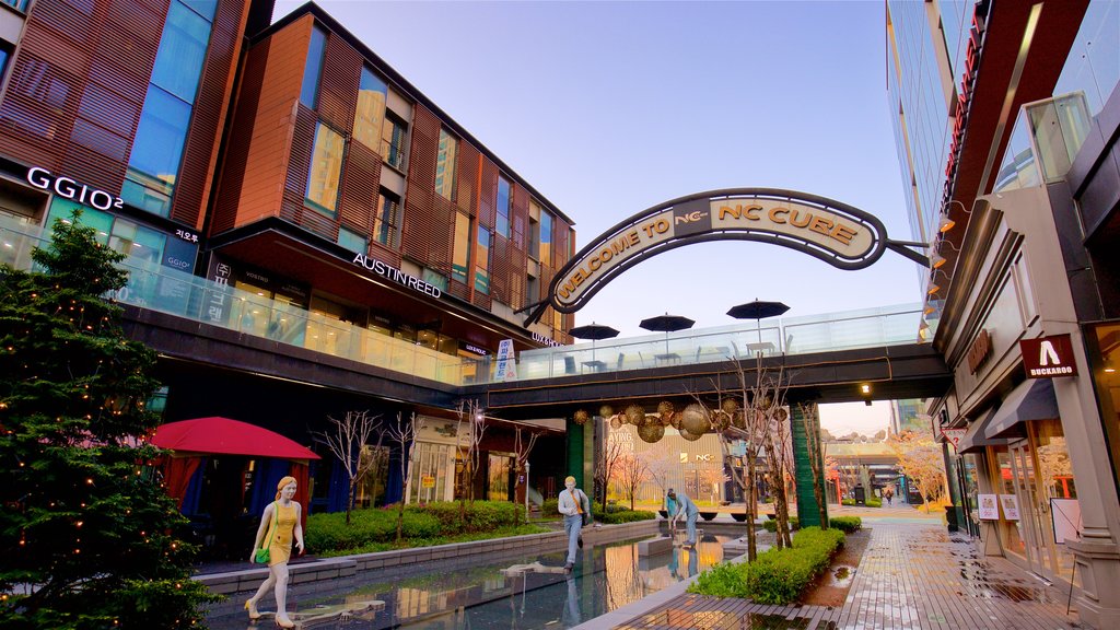 NC Cube Canal Walk showing signage, outdoor art and a sunset