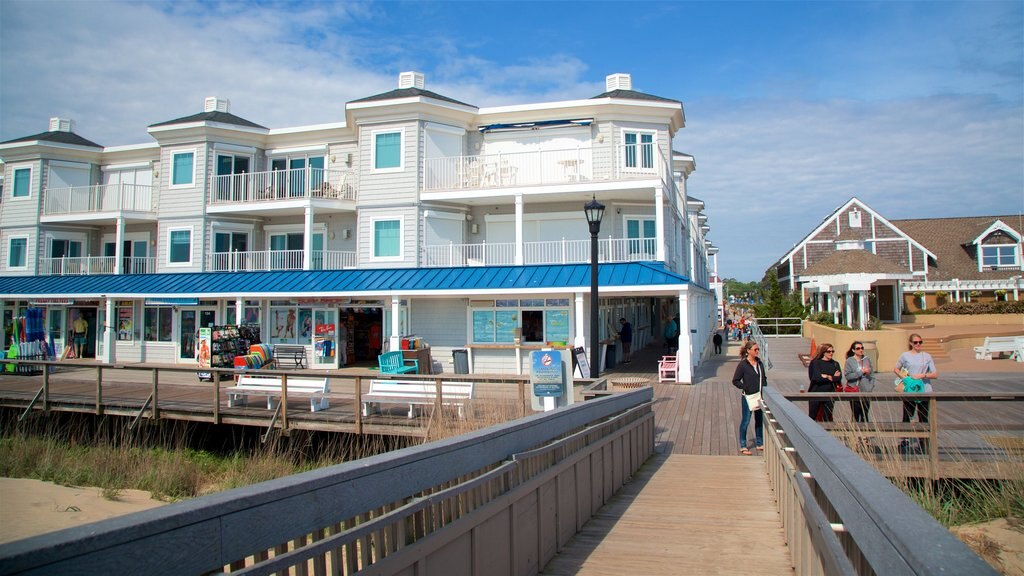 Bethany Beach showing a sandy beach and general coastal views as well as a small group of people