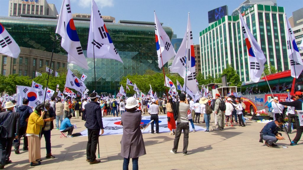 Sul mostrando uma praça ou plaza e uma cidade assim como um grande grupo de pessoas