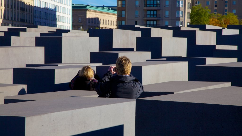 Holocaust Memorial showing a memorial as well as a couple