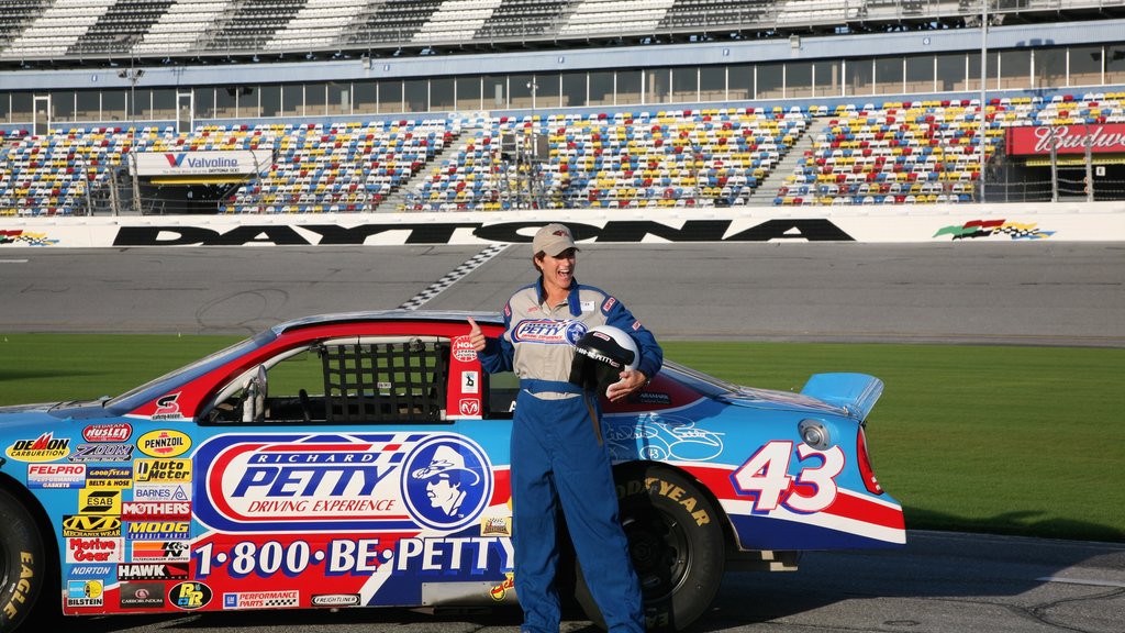 Daytona International Speedway showing a sporting event as well as an individual female