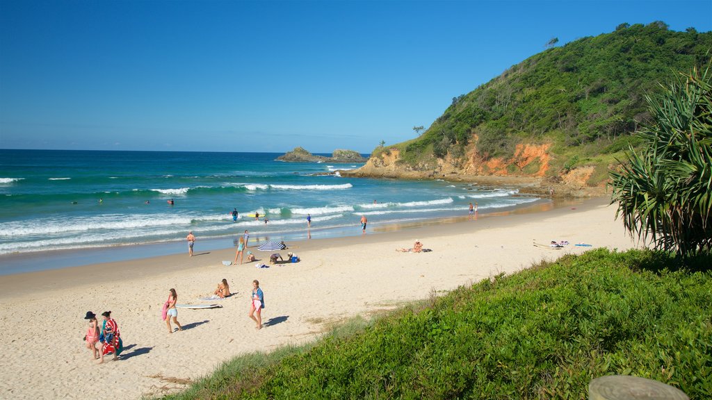 Byron Bay showing a sandy beach, general coastal views and rugged coastline