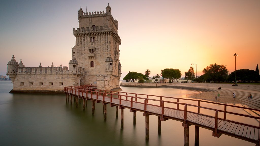 Belem Tower showing general coastal views, a sunset and heritage architecture