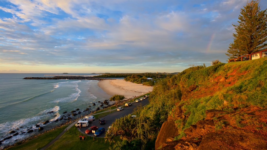 Point Danger que incluye una playa de arena, una puesta de sol y vistas de paisajes