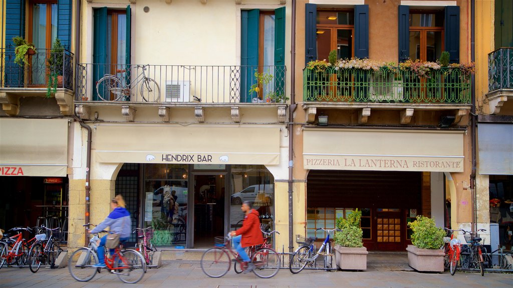 Piazza dei Signori showing road cycling and street scenes as well as a couple