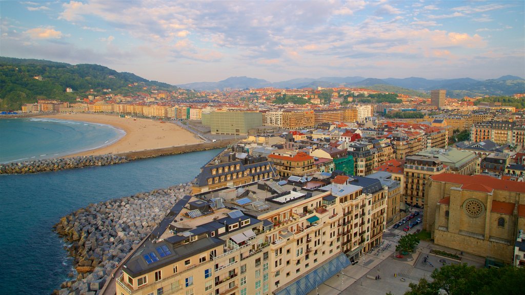 Monte Urgull which includes general coastal views, a coastal town and a sandy beach