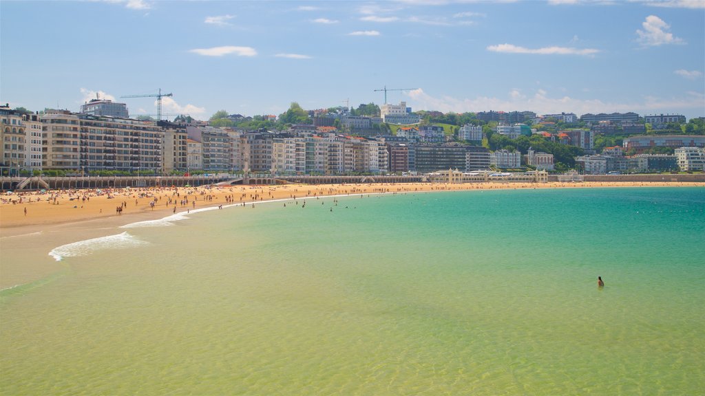 Concha Beach which includes a city, a beach and a coastal town