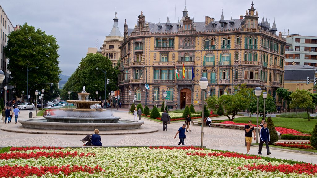 Praça Moyua que inclui uma fonte, um parque e arquitetura de patrimônio