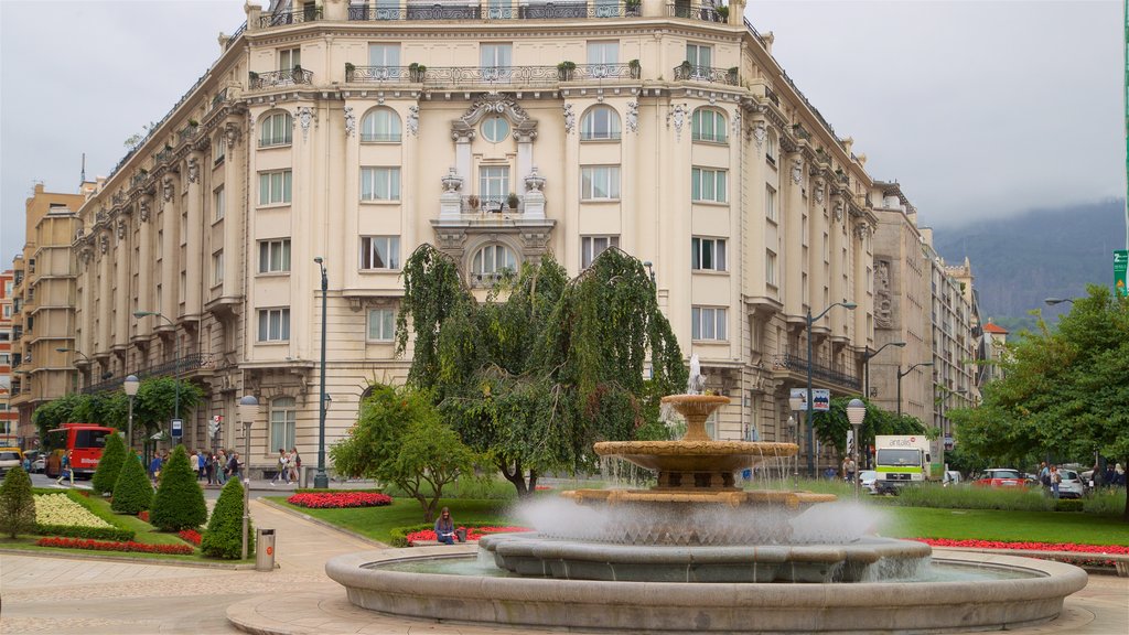 Plaza Moyua featuring a fountain, heritage architecture and a garden