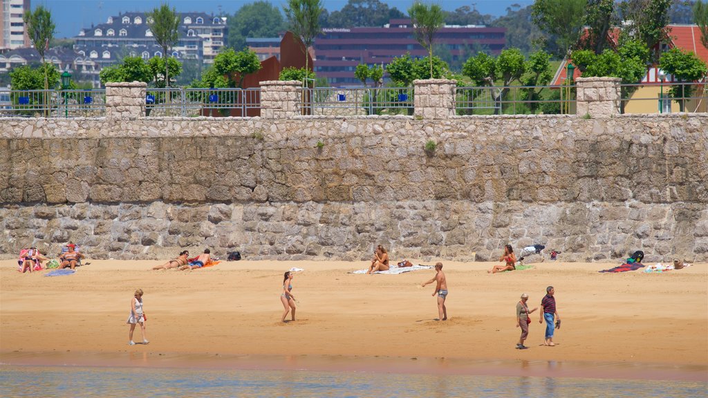 Playa de la Magdalena mostrando una ciudad costera, vistas generales de la costa y una playa