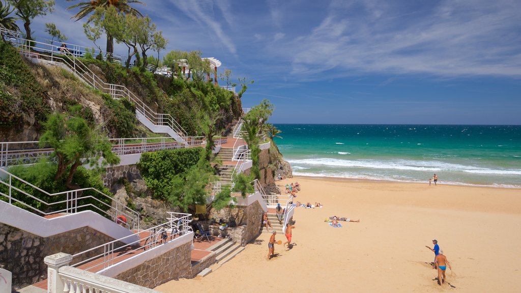 Jardines de Piquio showing a sandy beach and general coastal views as well as a small group of people