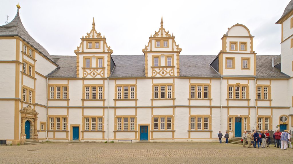 Neuhaus Castle showing street scenes and heritage architecture as well as a small group of people