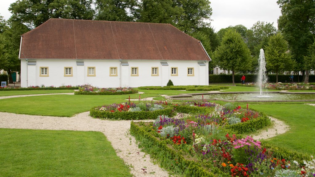 Neuhaus Castle which includes heritage elements, a fountain and flowers