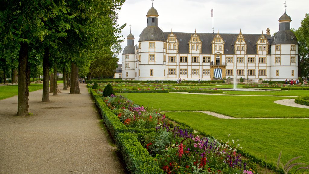 Neuhaus Castle which includes heritage architecture, a fountain and flowers