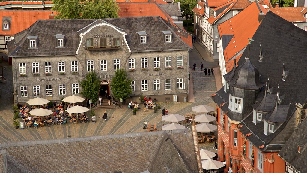 Market Church showing outdoor eating and a city as well as a small group of people