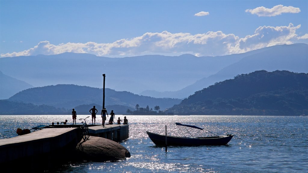 Enseada Beach featuring general coastal views as well as a small group of people