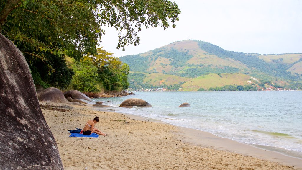 Eguas Beach featuring a sandy beach and general coastal views as well as an individual female