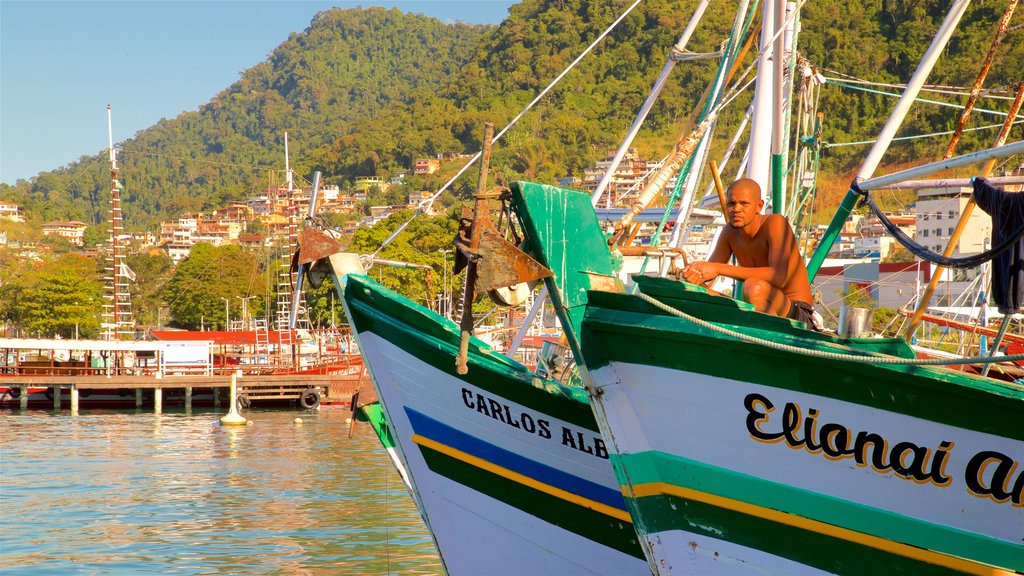 Angra dos Reis Port showing a bay or harbor as well as an individual male