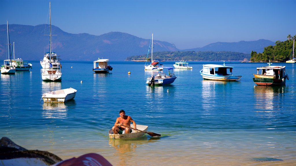 Bonfim Beach featuring a bay or harbour and kayaking or canoeing as well as an individual male