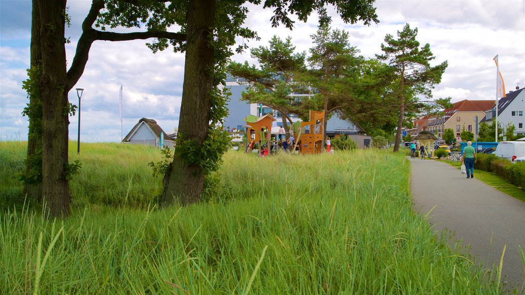 Scharbeutz showing a small town or village as well as an individual female