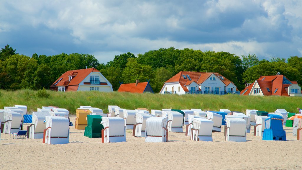 Warnemunde Beach which includes a sandy beach, a coastal town and general coastal views