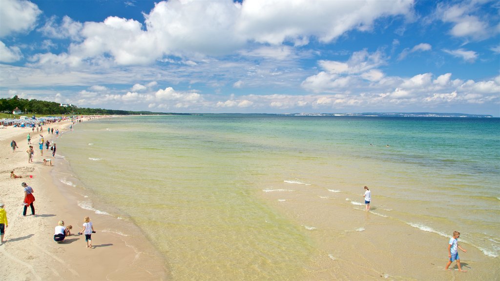 Playa de Binz que incluye una playa de arena y vistas generales de la costa y también un pequeño grupo de personas