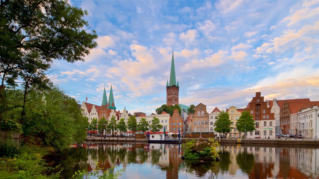 Petrikirche mettant en vedette un coucher de soleil, une ville et une rivière ou un ruisseau