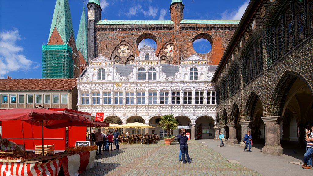 Rathaus showing a city and heritage architecture as well as a small group of people