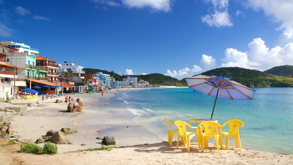 Prainha Beach which includes a coastal town, a sandy beach and general coastal views