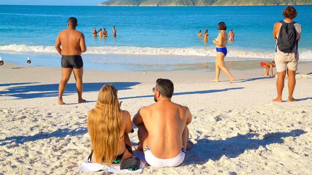 Pontal do Atalaia Beach showing general coastal views and a sandy beach as well as a couple