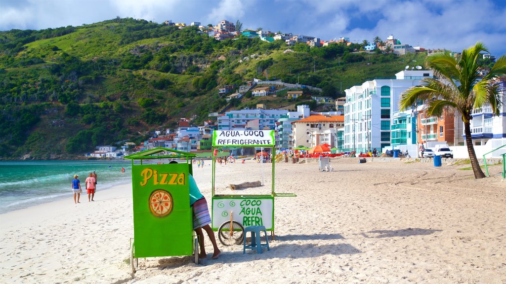 Prainha Beach showing a sandy beach, a coastal town and tropical scenes