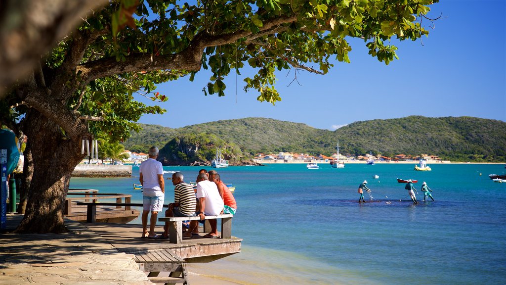 Armacao Beach showing general coastal views as well as a small group of people