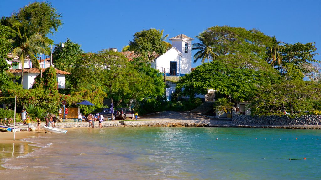 Ossos Beach showing a coastal town, a beach and general coastal views