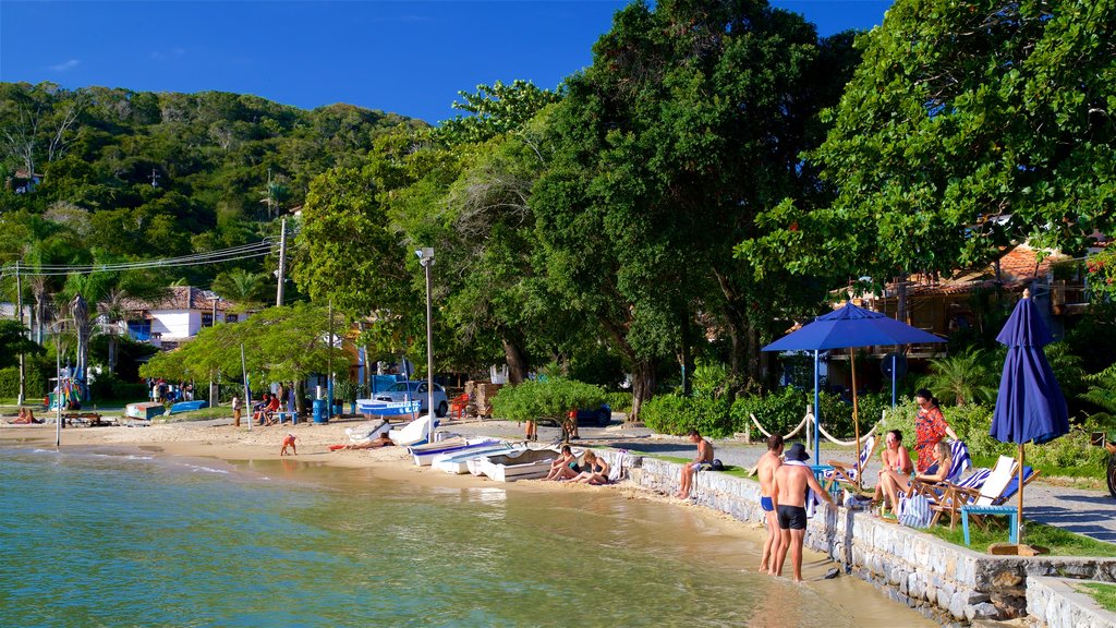 Ossos Beach showing a sandy beach and general coastal views as well as a small group of people