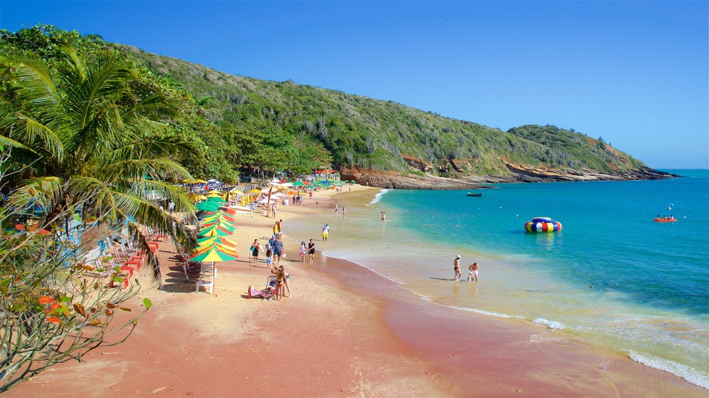 Joao Fernandes Beach which includes general coastal views and a sandy beach as well as a small group of people