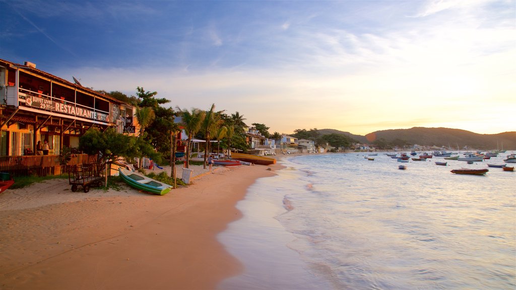 Orla Bardot showing a sunset, a sandy beach and a bay or harbour