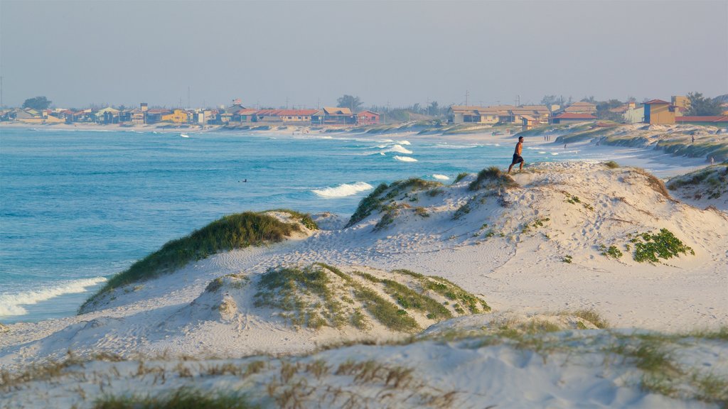 Dunas Beach which includes a beach, a coastal town and general coastal views